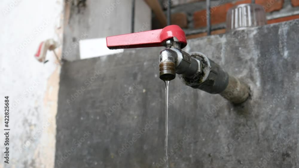 Broken tap closeup with dripping water-drop. Water leaking, saving concept, environmet conservation Broken tap closeup with dripping water-drop. Water leaking, saving concept, environmet conservation