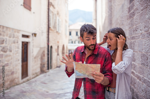 Tourist couple in new town with map © Novak