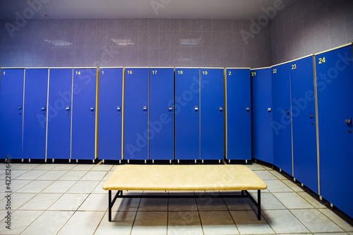 lockers in the gym locker room. bench in front of the shower. a place for athletes to change clothes after a competition and play sports
