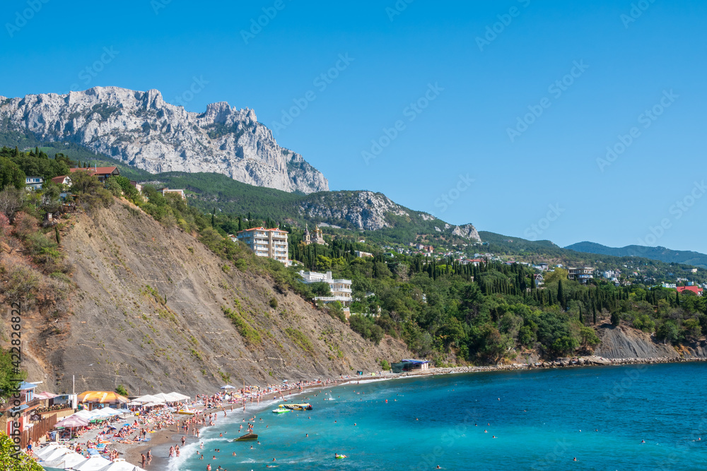 Sea view with rocky beaches and cliffs. Tourism in the Crimea. Summer photo of a sea landscape.