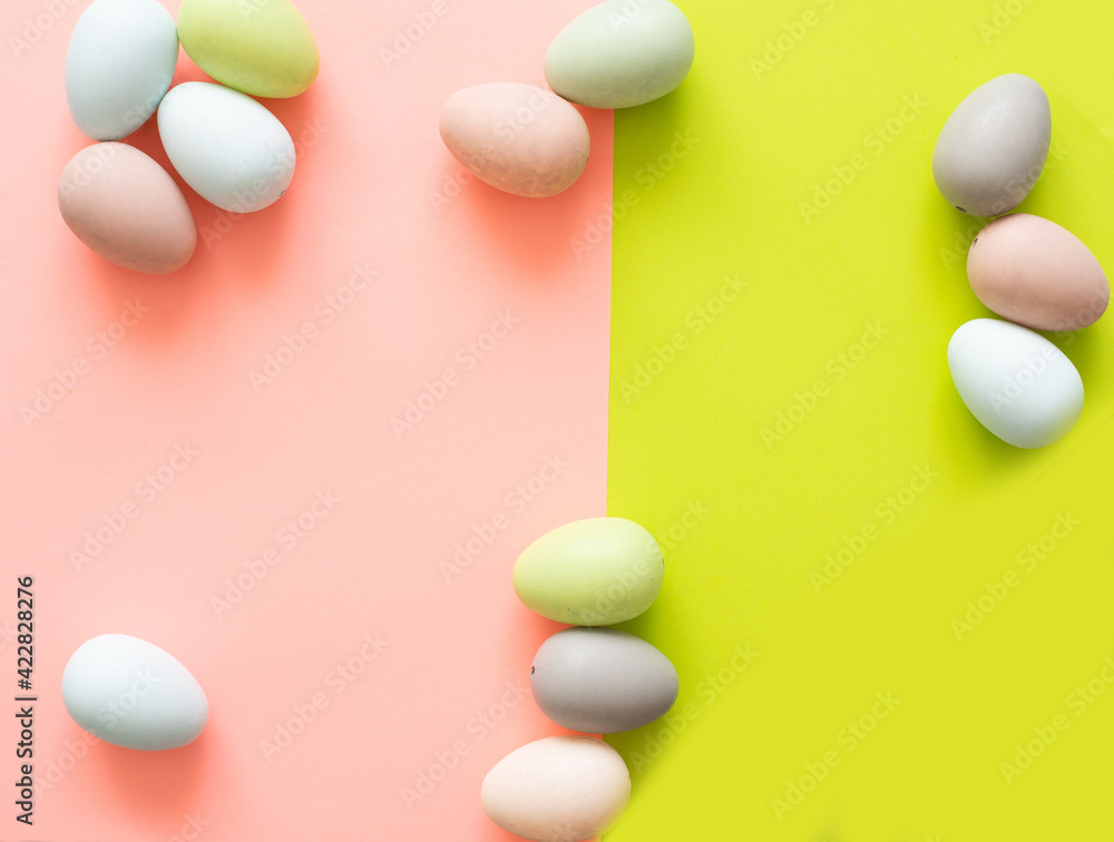 Colorful quail eggs on a light yellow background - an Easter composition. Background for greeting cards, invitations, greetings. Colorful quail eggs on a light yellow background - an Easter composition. Background for greeting cards, invitations, greetings.
