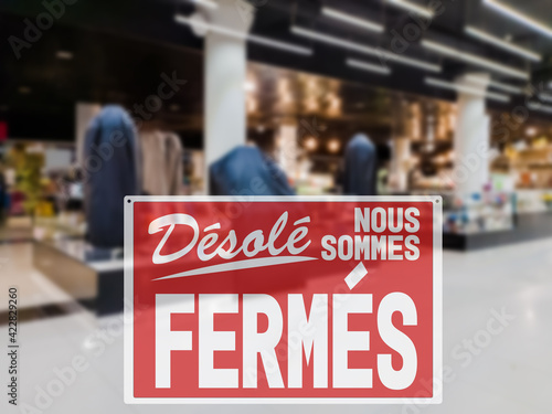 SORRY WE ARE CLOSED lettering in French. Concept of closing stores due to the introduction of a lockdown to avoid coronavirus spreading