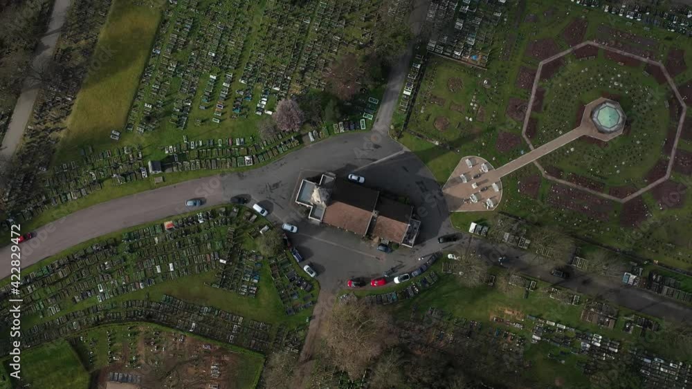 HIGH ANGLE TOP DOWN VIEW OF VEHICLES AND FAMILIES LEAVING CEMETERY HIGH ANGLE TOP DOWN VIEW OF VEHICLES AND FAMILIES LEAVING CEMETERY
