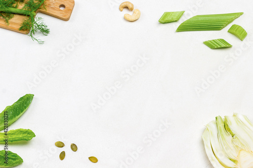 Flat lay composition with fresh greens on white background