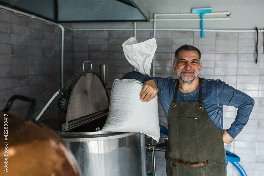middle aged man working in mini craft brewery middle aged man working in mini craft brewery