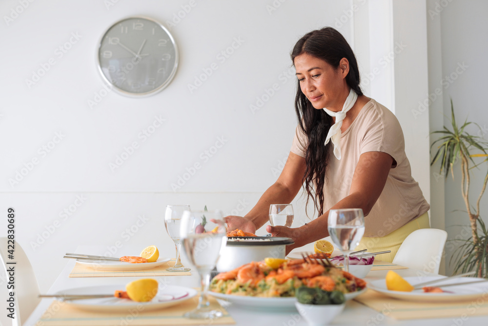 Beautiful adult woman laying down on the table asian food - Woman sharing filipino food with other people - Filipino woman waiting for guests at home