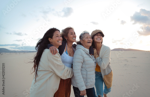 Family of four filipino women walking and hugging each other in a desert land - Beautiful women of different generations spending time together