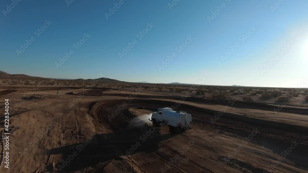 FPV - Water truck preparing motorcross race track in California City FPV - Water truck preparing motorcross race track in California City