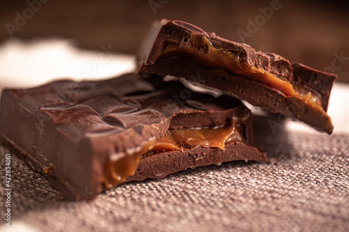 Broken assorted chocolate bar with caramel filling. Gluten free. Gourmet. Close up.