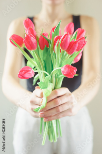 Spring bouquet of bright fresh tulips in hand.