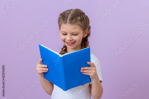 The girl really likes to read an interesting book.