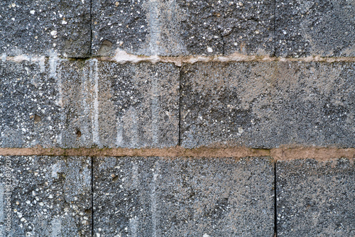 Old stone wall with structure of a garage. Background, texture, abstract.