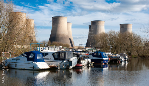 Small river boat moored near a power station photo