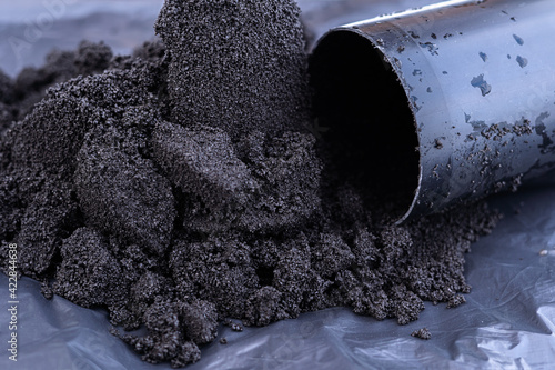 Pressed activated carbon for loading into a water filter photo