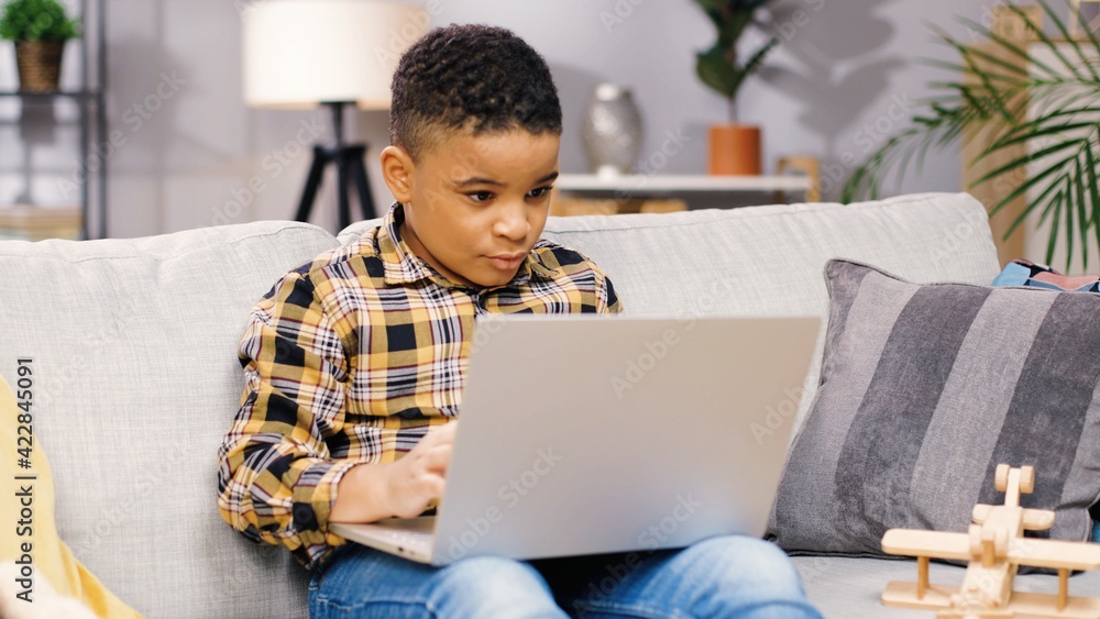 Close up of little African American kids sitting in living room at