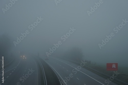 German motorway A7 in south of Hamburg during morning rush hour in pandemic - foggy winter 