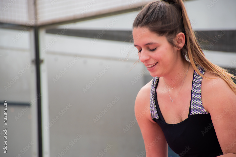 Close-up of a girl serving in a paddle match