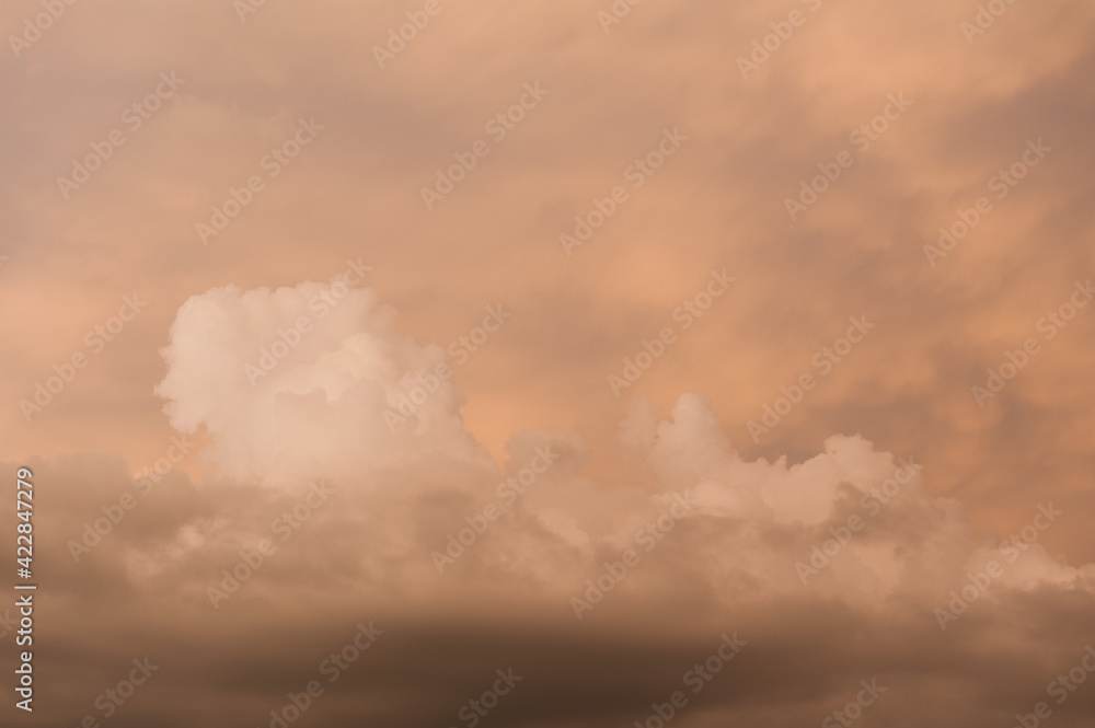 A piece of sky with dramatic, voluminous, storm clouds.