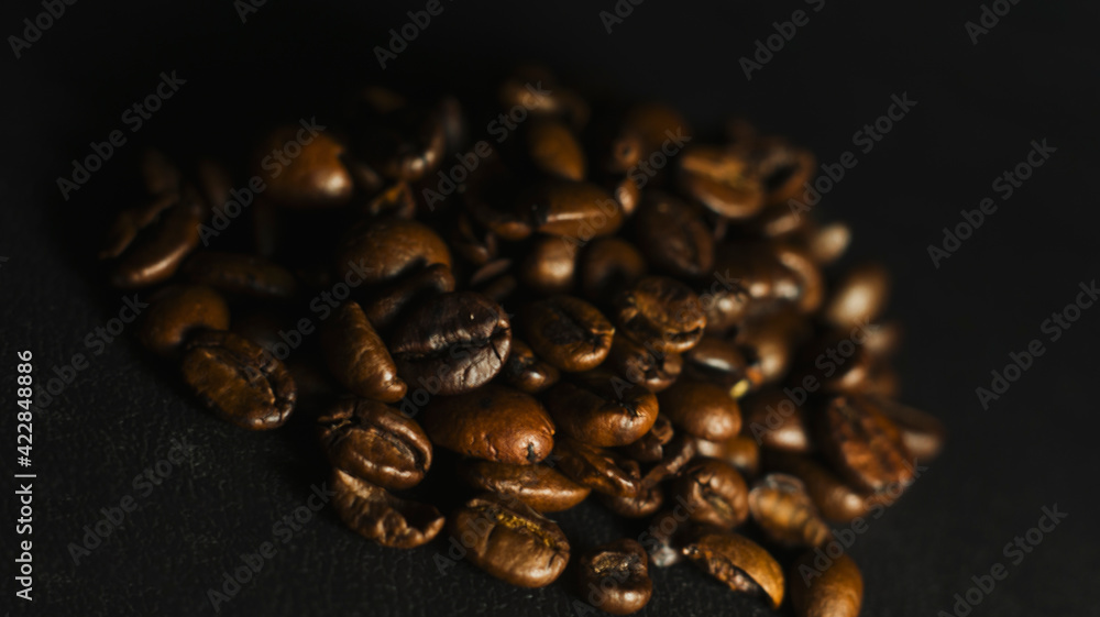 Fototapeta premium Brown Roasted Coffee Beans Closeup On Dark Background