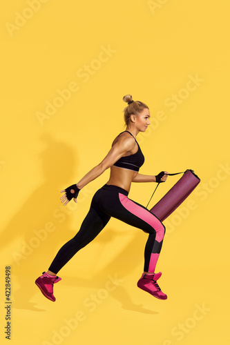 beautiful athletic woman in black sportswear running