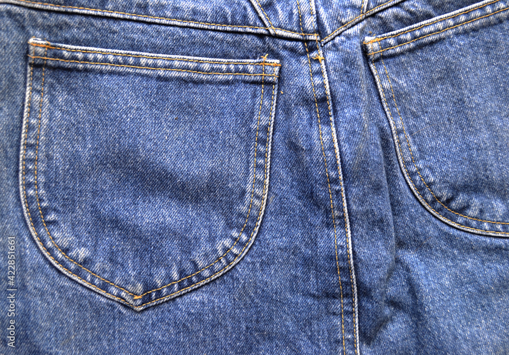 Closeup black and white blue jeans with pocket texture on gray background Closeup black and white blue jeans with pocket texture on gray background