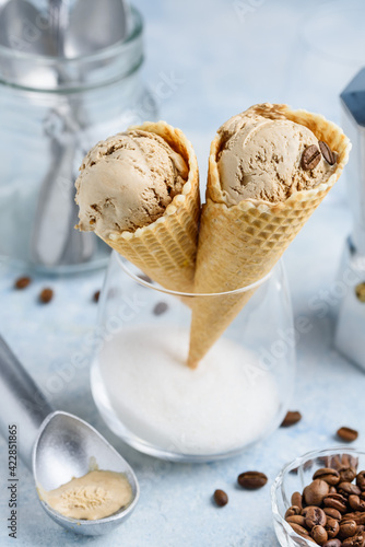 Coffee ice cream in a waffle cone in a glass. Delicious summer dessert. Selective focus. 