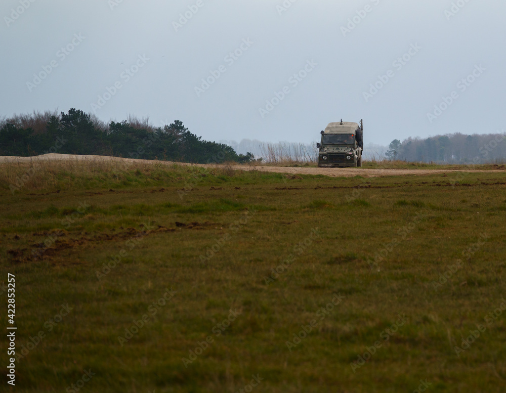 Fototapeta premium british army land rover defender 4x4 traversing a ditch