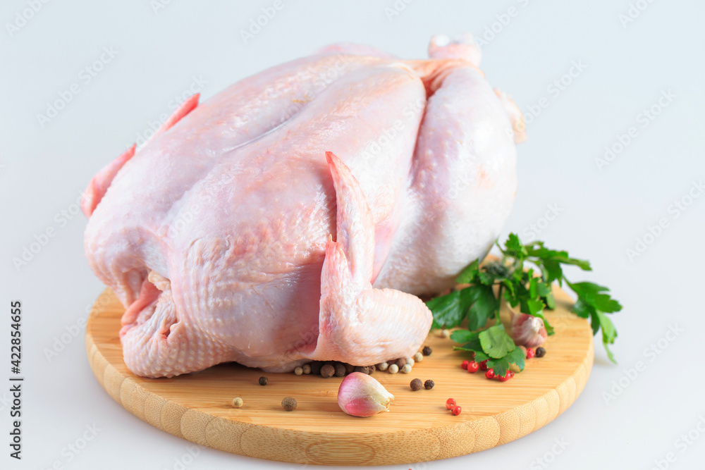 raw chicken carcass on the cutting board isolated on white background raw chicken carcass on the cutting board isolated on white background