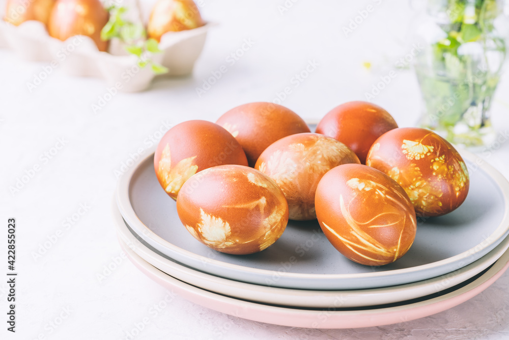 Natural dyed Easter eggs with onion shells and springtime plants Natural dyed Easter eggs with onion shells and springtime plants