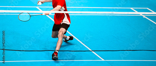 Professional badminton player beats the shuttlecock in the arena. Vintage color filter © Augustas Cetkauskas