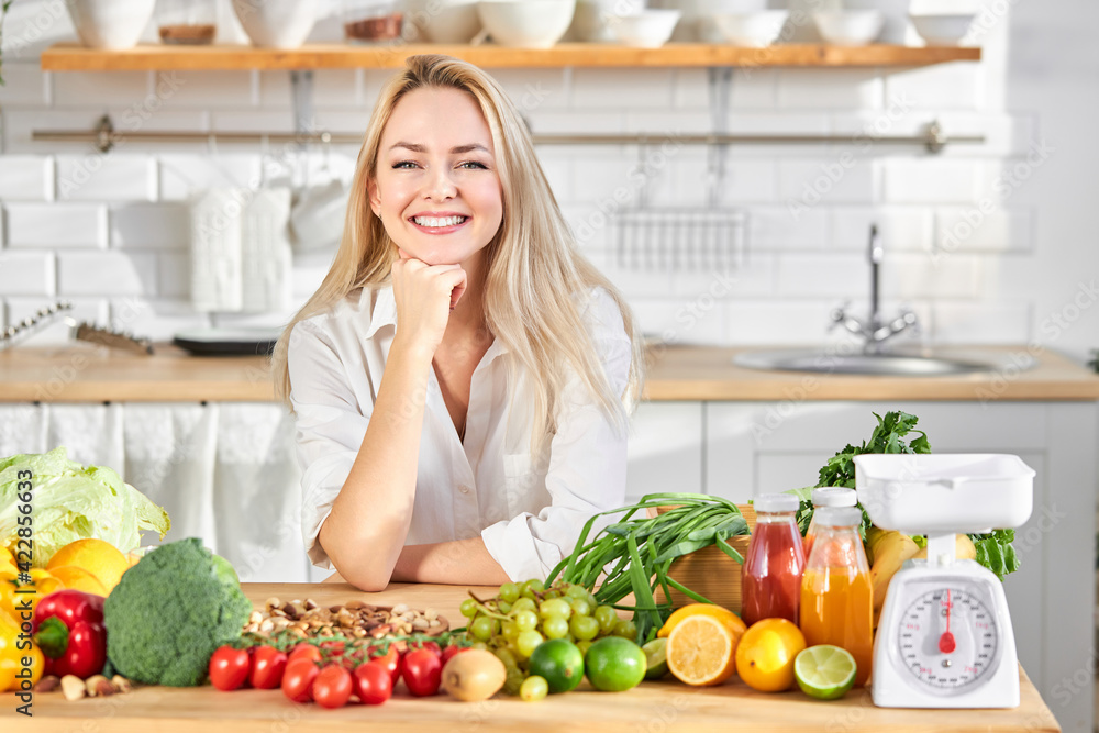 Woman and table with healthy food selection. Detox and clean diet. Foods high in vitamins, minerals and antioxidants