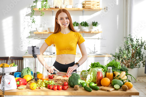 food blogger in casual wear record online video on mobile phone, show cooking process