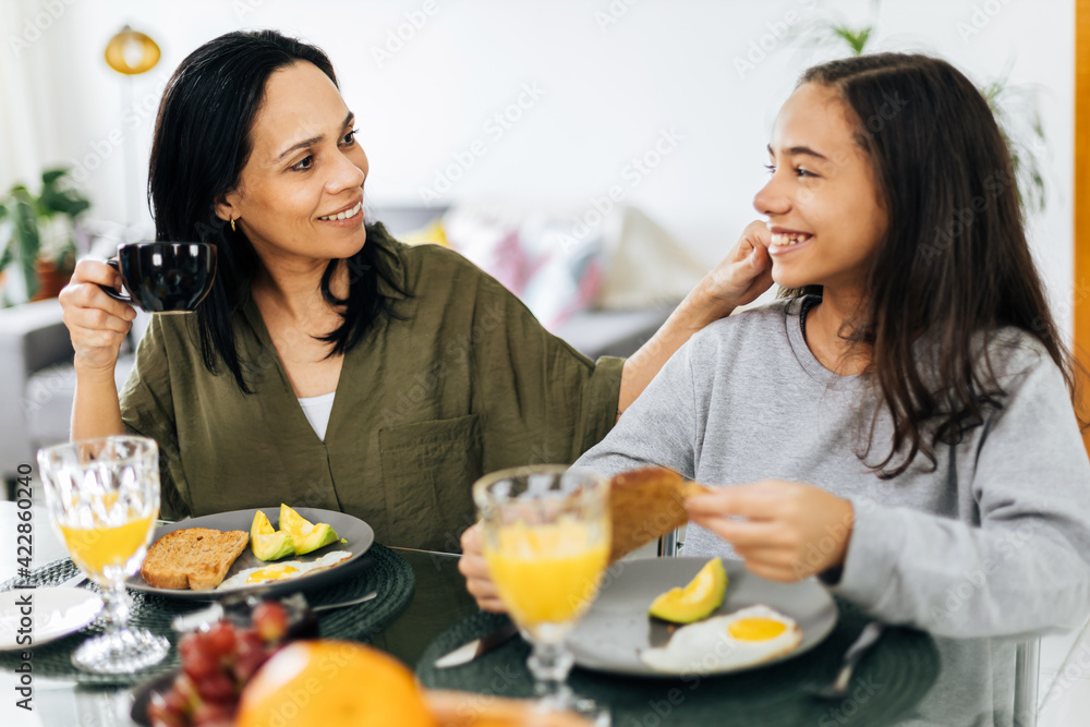 Single Parenthood. Mother and preteen daughter having breakfast at home. Single Parenthood. Mother and preteen daughter having breakfast at home.