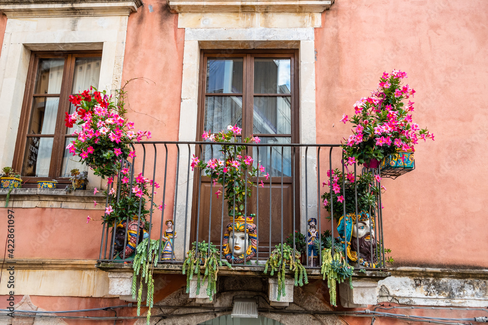 Typical Sicilian balcony in Taormina full of flowers and decorations