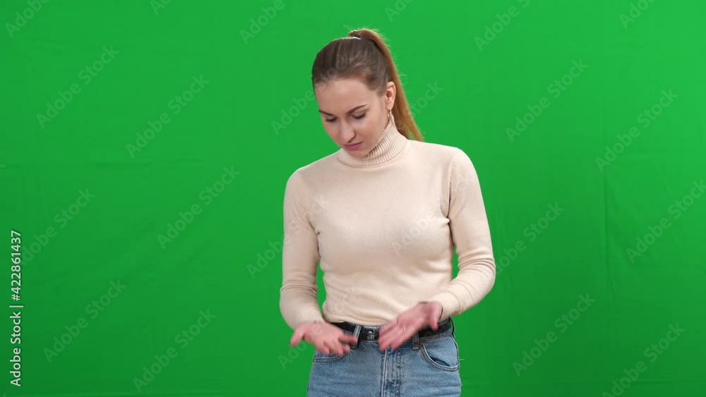 Portrait of young Caucasian woman smelling unpleasant smell on green screen. Slim beautiful lady making dissatisfied facial expression standing on chromakey background. Portrait of young Caucasian woman smelling unpleasant smell on green screen. Slim beautiful lady making dissatisfied facial expression standing on chromakey background.