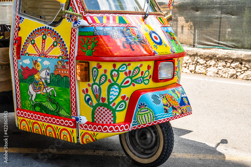 Amazingly decorated typical Apecar or three wheels car in Taormina, Italy