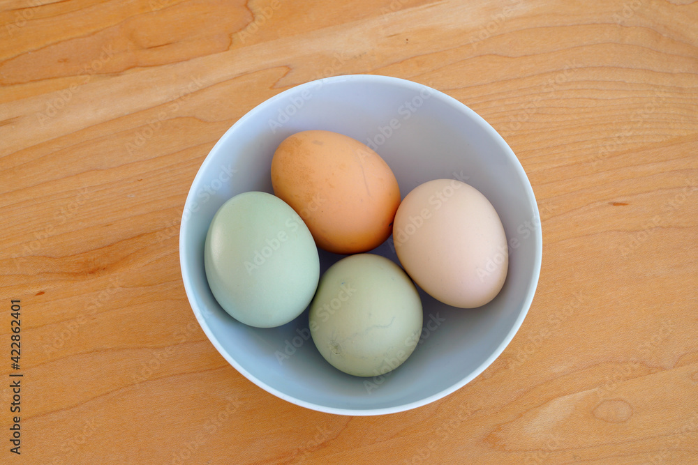 Bowl of colorful brown and grey free-range pasture-raised organic eggs from heritage hens Bowl of colorful brown and grey free-range pasture-raised organic eggs from heritage hens