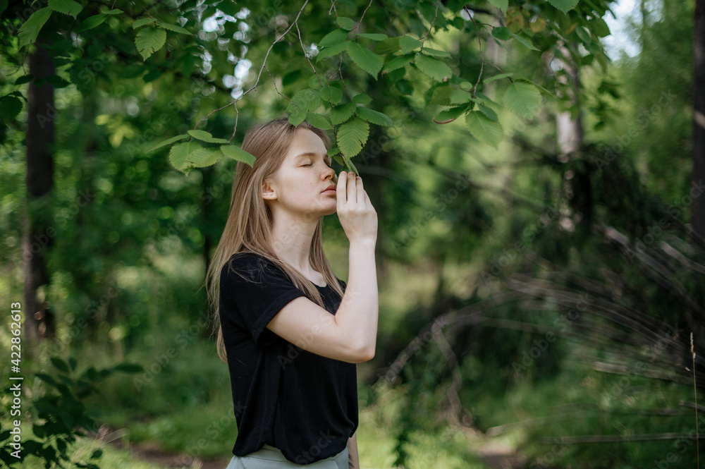 Practice of meditation and interaction with nature. Girl in green forest Practice of meditation and interaction with nature. Girl in green forest