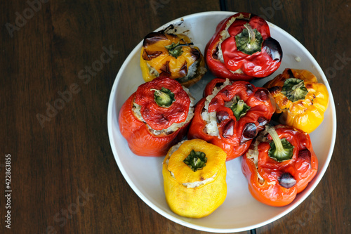 Grilled peppers stuffed with minced meat on a white plate