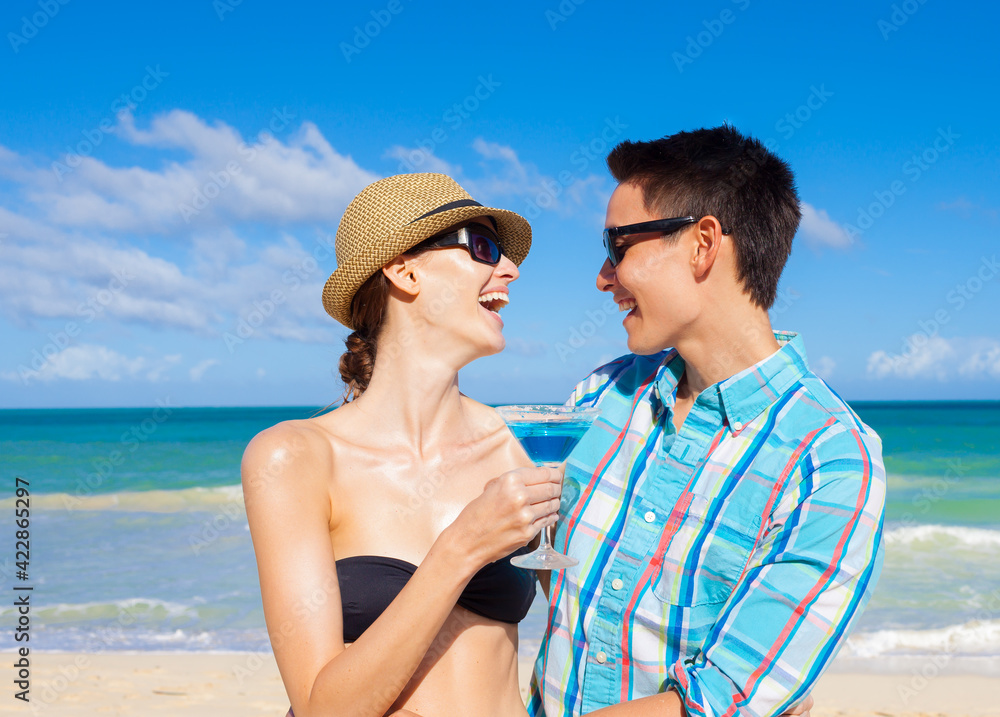 Happy young couple enjoying beach vacation party celebration
