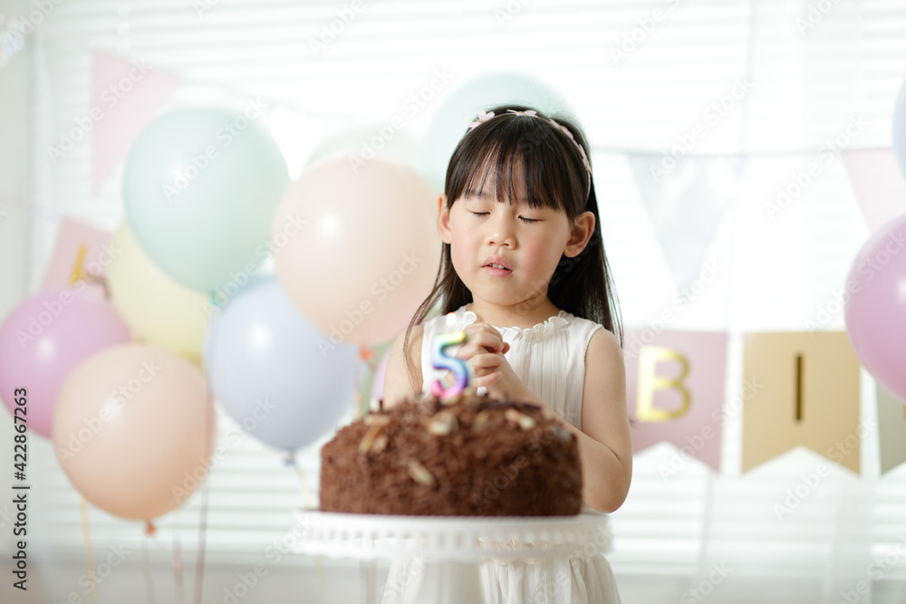 young girl celebrating her 5th birthday at home young girl celebrating her 5th birthday at home