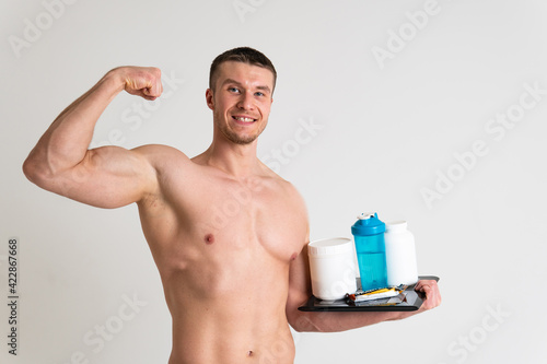 Fotografie Fitness protein jars white on white background bodybuilder powder strong high ache hurt injury, person isolated massage medical, holding