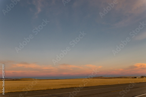 Beautiful sunset sky over a prairie landscape © Tanya