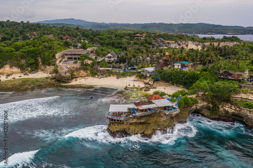 Dramatic aerial view of the .Mahana Point.on the rugged coast of the Ceningan island in Bali province in Indonesia in Southeast Asia photo