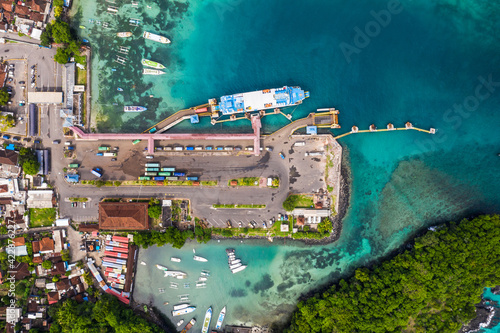 Top down view of the Padang Bai harbor in Bali, Indonesia, where trucks get out of a roro car ferry coming from Lombok © jakartatravel
