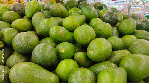 Avocados at foodmart market. Healthy food background. Avocado fruit at farmers market. photo