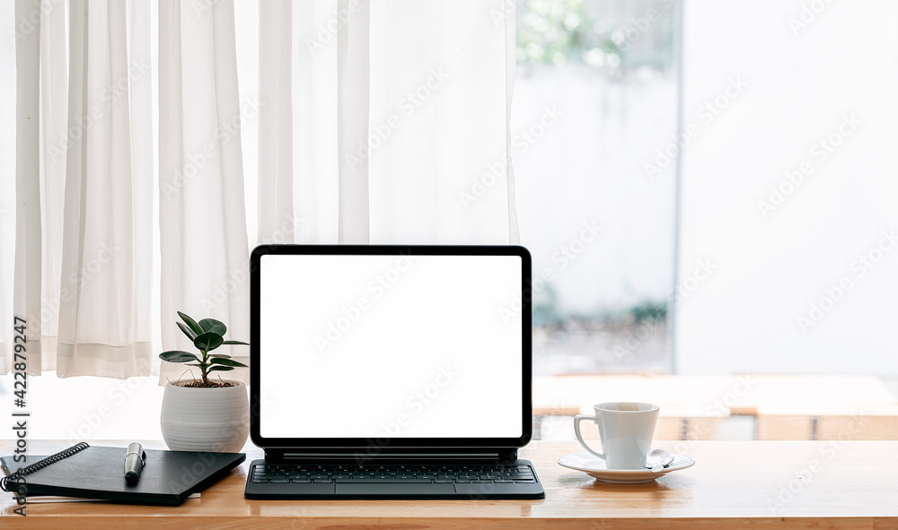 Blank screen talet with keyboard on wooden table in modern living room. Blank screen talet with keyboard on wooden table in modern living room.