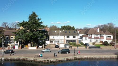 MAN JOGGING ALONSIDE A POND WITH A BEAUTIFUL CITYSCAPE, EUROPE, LONDON AERIAL photo