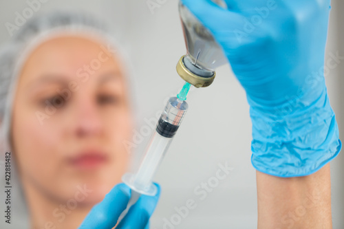 Female nurse ready to make injection in hospital