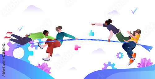 mix race people playing tag of war friends pulling rope competition between teams